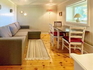 a living room with a couch and a table at Two-Bedroom Holiday home in Laupstad 4 in Vestpollen