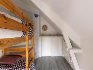 a room with two bunk beds and a staircase at Nice holiday home in Isigny sur Mer with garden in Isigny-sur-Mer