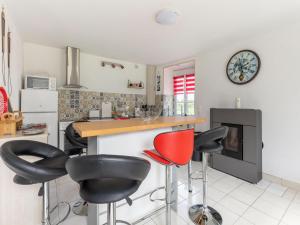 a kitchen with black and red bar stools at Nice holiday home in Isigny sur Mer with garden in Isigny-sur-Mer