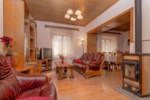 a living room with a leather couch and a table at Holiday house with a parking space Svirce, Hvar - 17682 in Vrbanj
