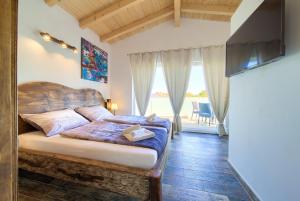 een slaapkamer met een bed in een kamer met een raam bij Family friendly house with a swimming pool Vrh, Krk - 17760 in Vrh
