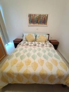 a bedroom with a bed and a painting on the wall at New, Modern, and Cozy 3 Bedroom Apartment. in Santa Maria