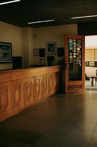 a bar in a restaurant with a door and a car at Olympia Hotel in Lorena
