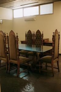 een eetkamer met een tafel en stoelen en een raam bij Olympia Hotel in Lorena
