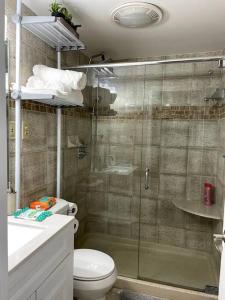a bathroom with a shower and a toilet and a sink at Home Away from Home Condo Downtown ATL 16th floor in Atlanta