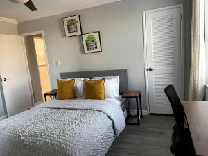 a bedroom with a bed with yellow pillows at Home Away from Home Condo Downtown ATL 16th floor in Atlanta