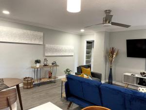 a living room with a blue couch and a tv at Home Away from Home Condo Downtown ATL 16th floor in Atlanta