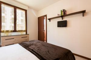 A television and/or entertainment centre at Castelnuovo Flat with Elevator and Free Parking