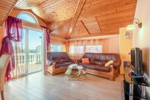 a living room with two leather couches and a tv at Apartments by the sea Kraj, Pasman - 17783 in Tkon