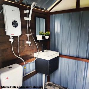 a bathroom with a sink and a shower in it at Glamz Hills in Cameron Highlands