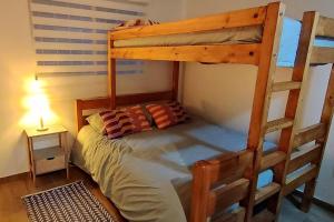 a bedroom with a bunk bed with a ladder at Reñaca. Increíble vista al mar, pasos del sector 5 in Viña del Mar +8 photos