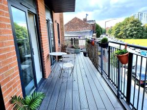 a balcony with a table and chairs on a building at Luxury 2-Bedroom Service Apartment with Balcony in Manchester