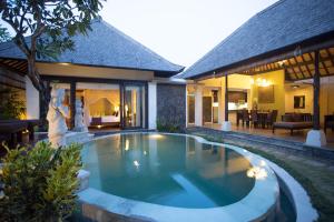 a swimming pool in the backyard of a villa at The Sanyas Suite Bali in Seminyak