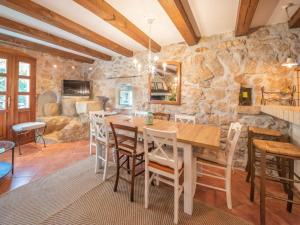 uma sala de jantar com uma parede de pedra e uma mesa e cadeiras em Family friendly house with a swimming pool Zagore, Opatija - 17924 em Mošćenička Draga