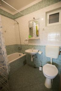 a bathroom with a toilet and a sink and a tub at Apartments by the sea Vis - 17960 in Vis