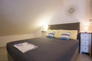 a bedroom with a large bed with blue and white pillows at Apartments by the sea Vis - 17960 in Vis