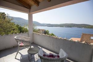 a balcony with chairs and a view of the water at Apartments by the sea Vis - 17960 in Vis