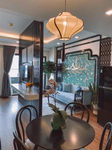 a living room with a couch and a table at Q House- FLC Sea Tower in Quy Nhon