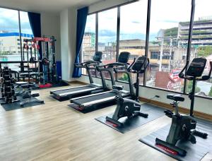 a gym with several tread machines and a large window at Banbua Grand Udon in Udon Thani