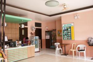 a restaurant with a counter and chairs in a room at GV Hotel - Maasin in Maasin