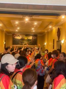 um grupo de pessoas numa sala com as mãos no ar em Nice Guesthouse em Phnom Penh