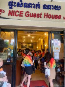 a group of people standing outside of a nice guest house at Nice Guesthouse in Phnom Penh
