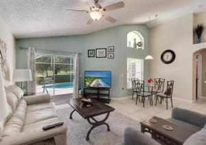 a living room with a couch and a table at Lovely Home in Southern Dunes Golf & Country Club Gated Community in Haines City