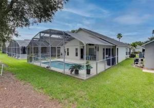 a house with a swimming pool in a yard at Lovely Home in Southern Dunes Golf & Country Club Gated Community in Haines City