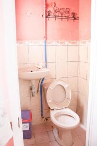 a bathroom with a toilet and a sink at GV Hotel - Maasin in Maasin