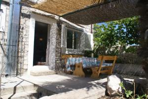 a table and chairs in front of a house at Holiday house with WiFi Zlarin - 17998 in Zlarin