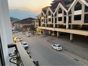 a view of a city street with cars on the road at ChiChi Hotel Sapa in Sapa