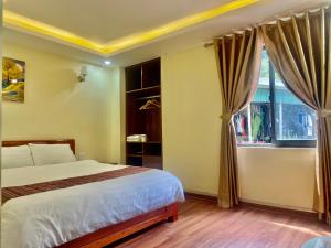a bedroom with a bed and a window at ChiChi Hotel Sapa in Sapa +11 photos