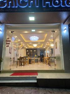 a store front of a restaurant with tables and chairs at ChiChi Hotel Sapa in Sapa