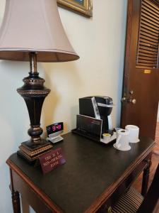 a lamp sitting on top of a table with a microwave at The Faust Hotel in New Braunfels