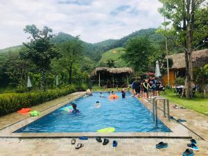a group of people in a swimming pool at Om Tara Retreat in Yen Bai