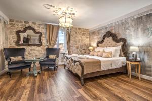 a bedroom with a bed and a chair and a mirror at Rooms by the sea Split - 18081 in Split