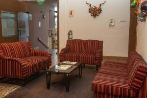 a waiting room with two chairs and a coffee table at Casa Andina Standard Puno in Puno