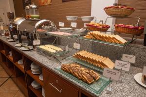 a buffet with bread and pastries on a counter at Casa Andina Standard Puno in Puno