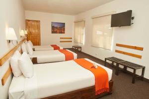 a hotel room with two beds and a flat screen tv at Casa Andina Standard Puno in Puno