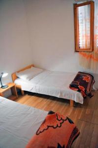 a bedroom with two beds and a window at Apartments by the sea Ivan Dolac, Hvar - 18100 in Jelsa