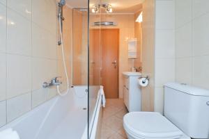 a bathroom with a shower and a toilet and a sink at Family friendly apartments with a swimming pool Kozino, Zadar - 18121 in Kožino