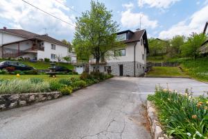 Apartments with a parking space Slunj, Plitvice - 18152 في سلوني: ممر فارغ امام البيت الابيض