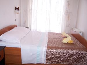 a bed with two towels on it with a window at Apartments by the sea Novalja, Pag - 18154 in Novalja