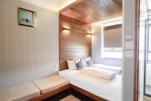 Ένα ή περισσότερα κρεβάτια σε δωμάτιο στο Lychee Sunset Hotel Cheung Chau