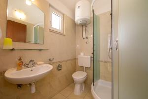 a bathroom with a sink and a toilet and a shower at Apartments by the sea Igrane, Makarska - 18069 in Igrane +27 photos