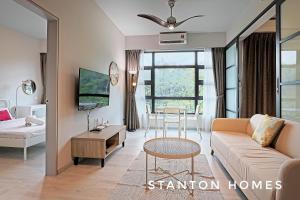 a living room with a couch and a table at Jesselton Quay HOMESTAY by Stanton Homes in Kota Kinabalu