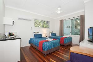 a bedroom with a bed and a desk at La Costa Beachside Motel in Gold Coast