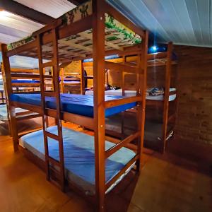 a group of bunk beds in a room at Efferus Hostel in Ubatuba