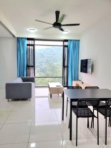 een woonkamer met een bank en een tafel en stoelen bij Studio at The Ridge KL East W in Kuala Lumpur