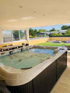 a large hot tub in the middle of a building at La terrasse du parc in Marckolsheim